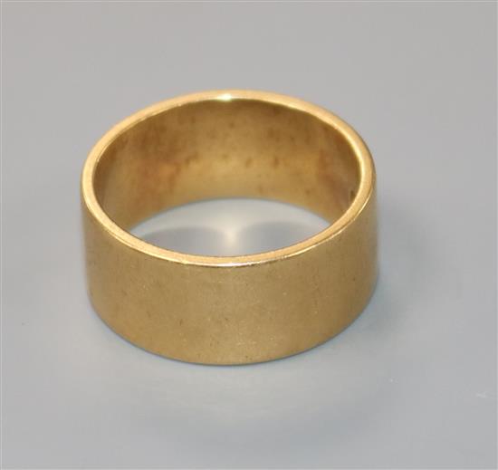 An 18ct yellow gold wide wedding band, size T.